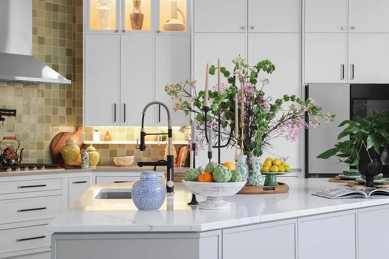 North Austin kitchen after the Spaces Designed remodel, white cabinetry with a sage tile backsplash